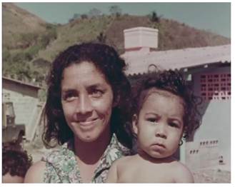 Una madre que sonríe con su hijo en brazos